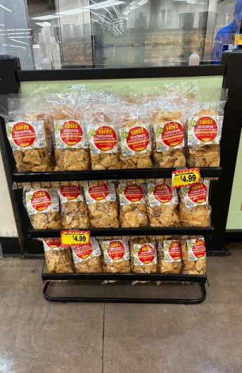 Mexican snacks displayed in a supermarket rack, featuring corn snacks such as totopos produced by Orendain Brands.